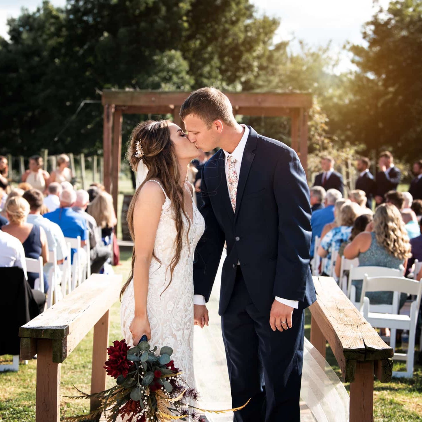 Bride and groom sharing a kiss after wedding ceremony